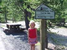 Summer and sign pointing the way to Obsidian Trail